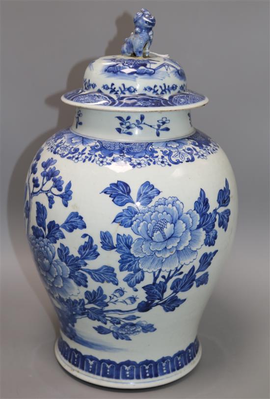 A Chinese blue and white painted lidded baluster vase, painted with blossoming peonies height 45cm, cracked